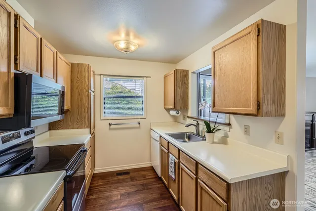 a kitchen with wooden cabinets and a stove top oven