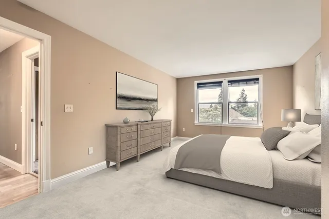 a spacious bedroom with a bed and a window