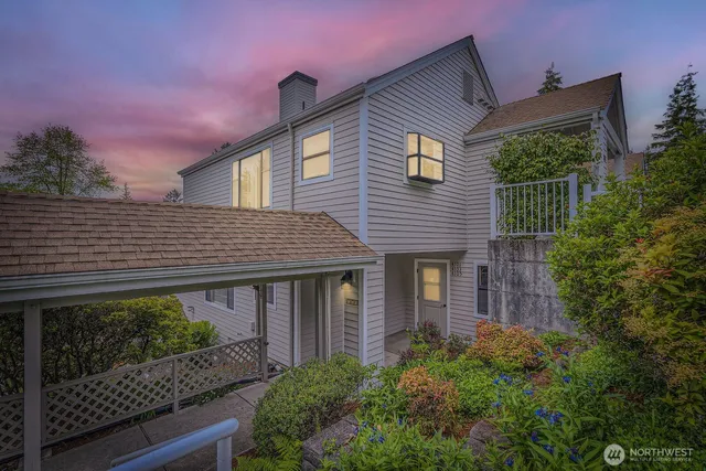 a front view of a house with plants