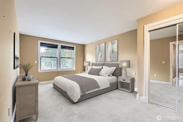 a spacious bedroom with a large bed and potted plant next to a window