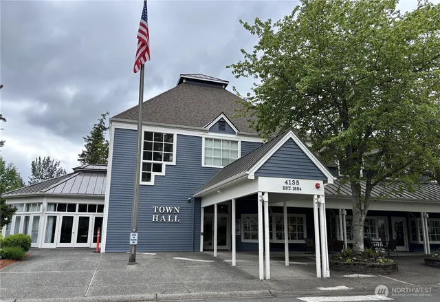 a view of a workspace with furniture and book shelf