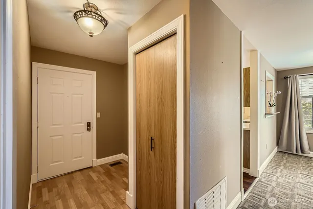 a living room with furniture a fireplace and a floor to ceiling window