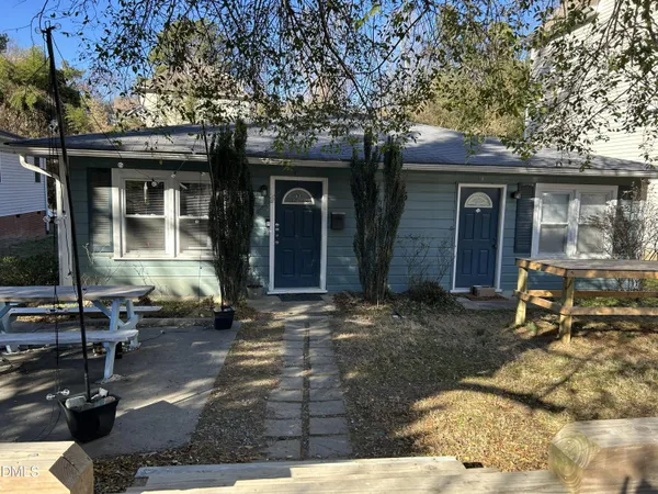a front view of a house with sitting area