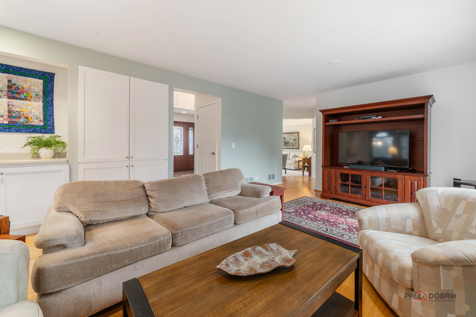 609 Raintree Road Buffalo Grove, IL 60089 - Photo 13 of 48 a living room with furniture and a flat screen tv