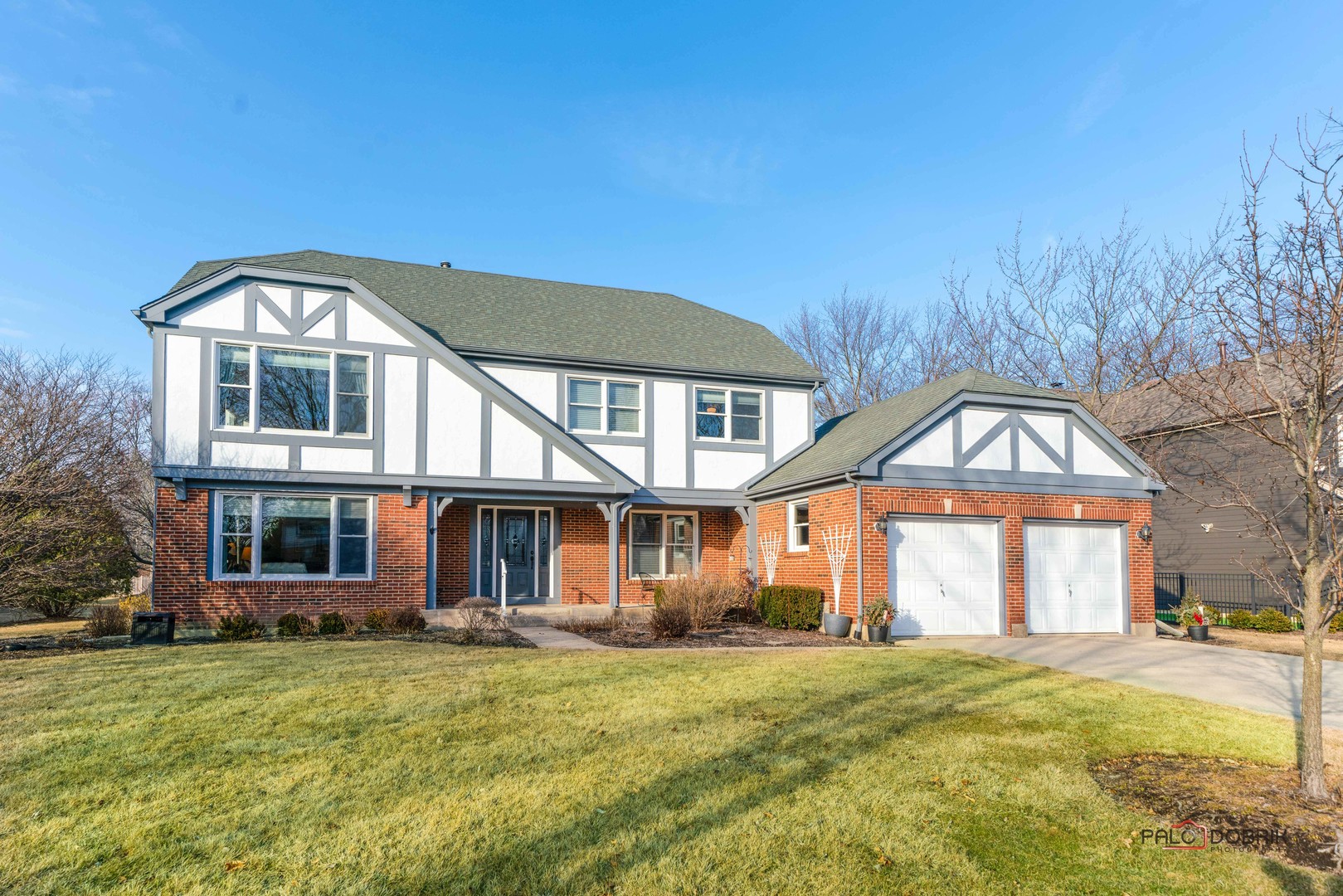 609 Raintree Road Buffalo Grove, IL 60089 - Photo 2 of 48 a front view of a house with a garden