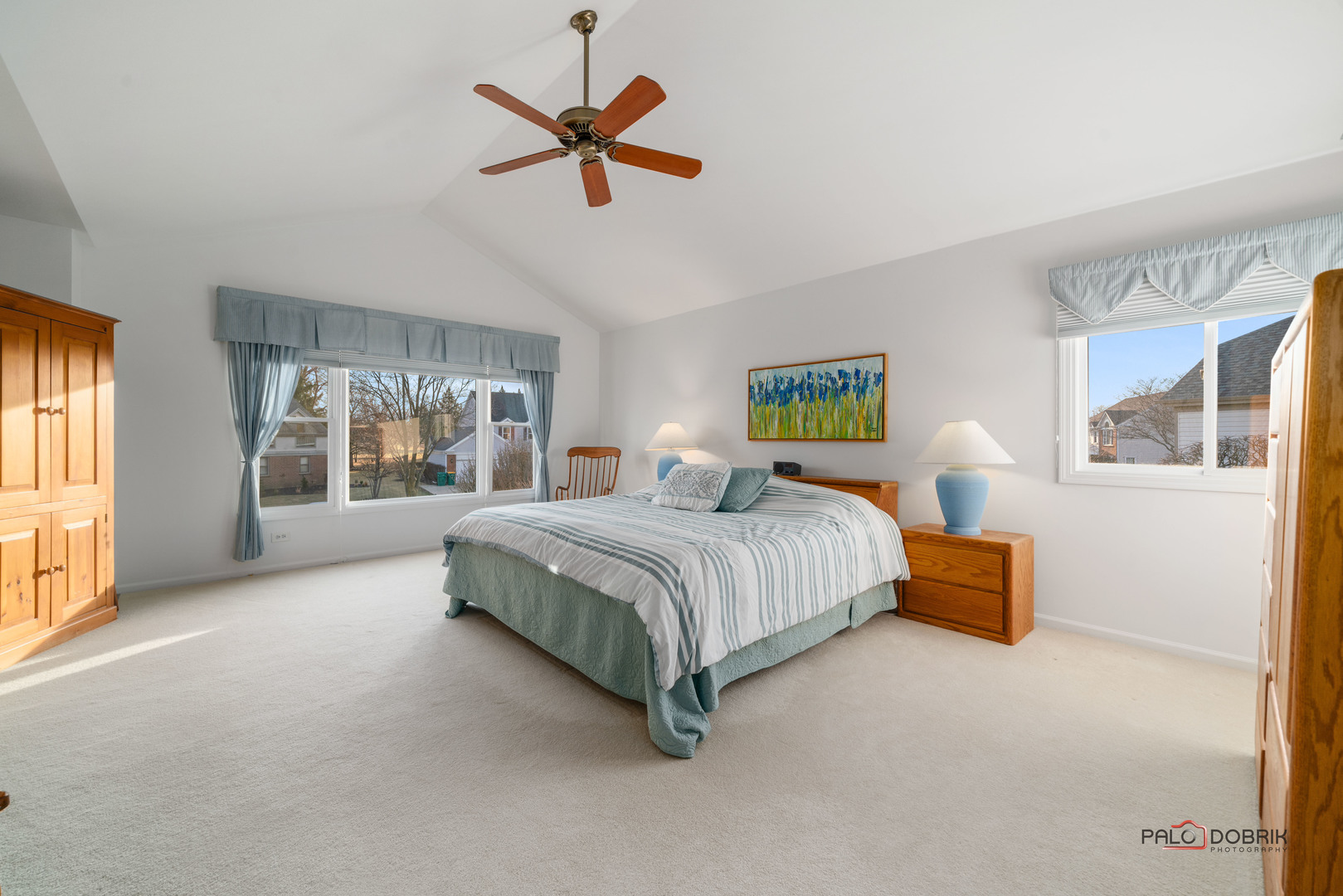 609 Raintree Road Buffalo Grove, IL 60089 - Photo 22 of 48 a bedroom with a large bed and a chandelier