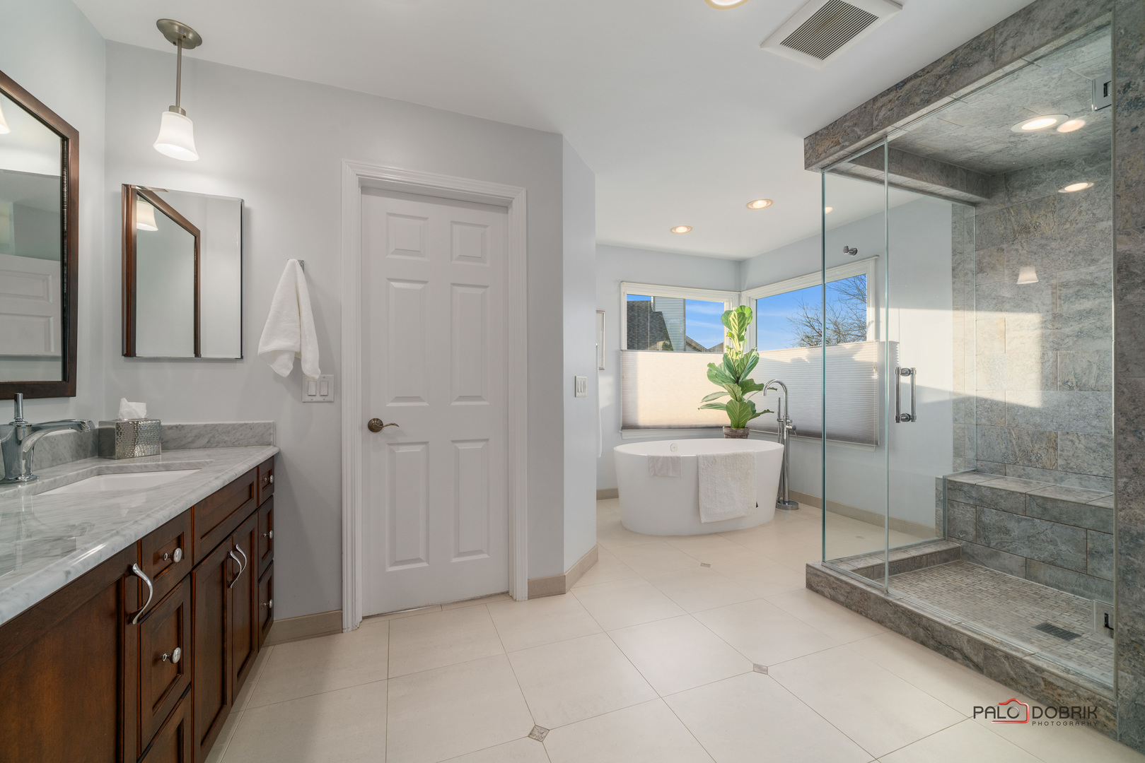 609 Raintree Road Buffalo Grove, IL 60089 - Photo 24 of 48 a bathroom with a double vanity sink a toilet a mirror and shower