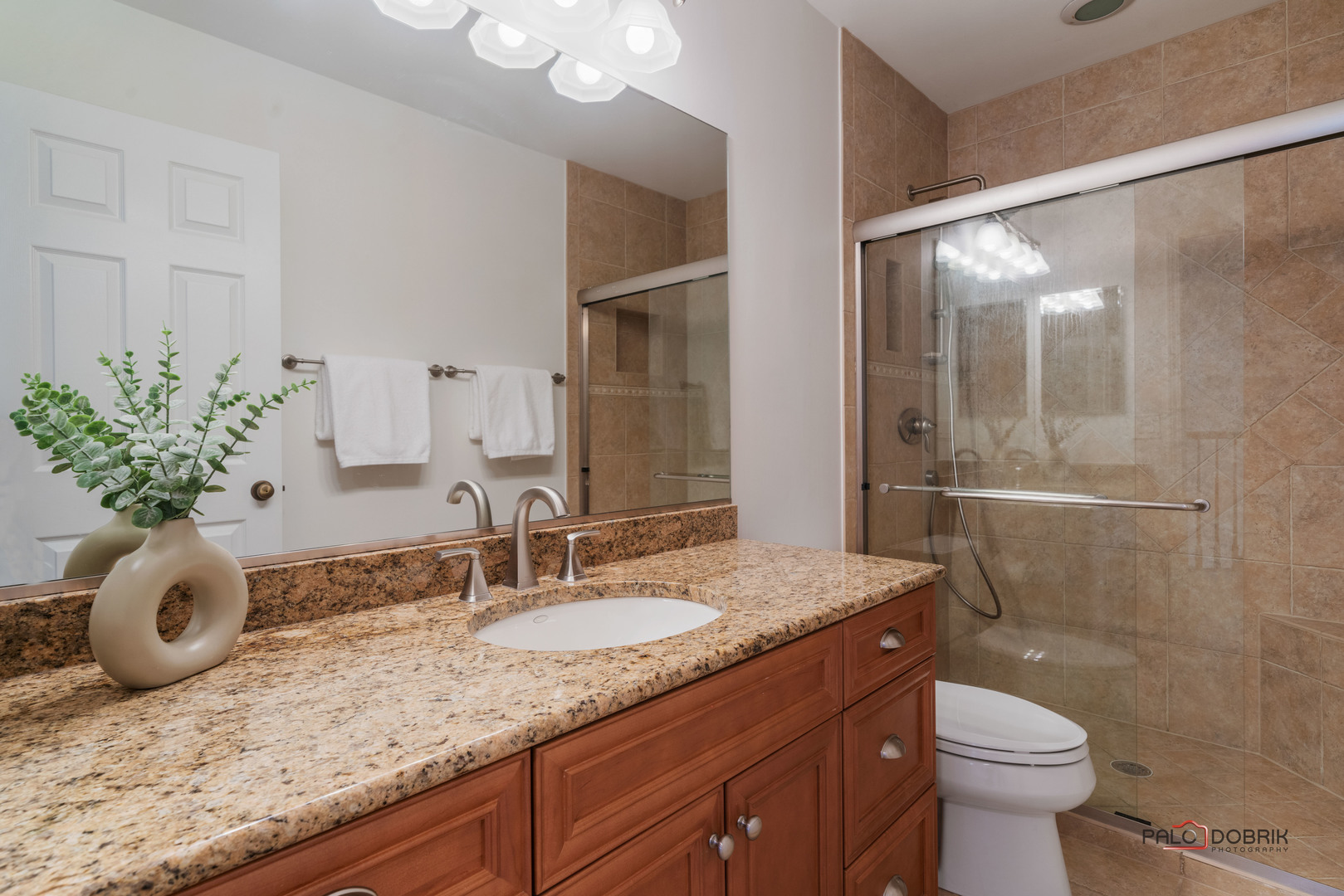 609 Raintree Road Buffalo Grove, IL 60089 - Photo 31 of 48 a bathroom with a granite countertop sink a toilet and mirror