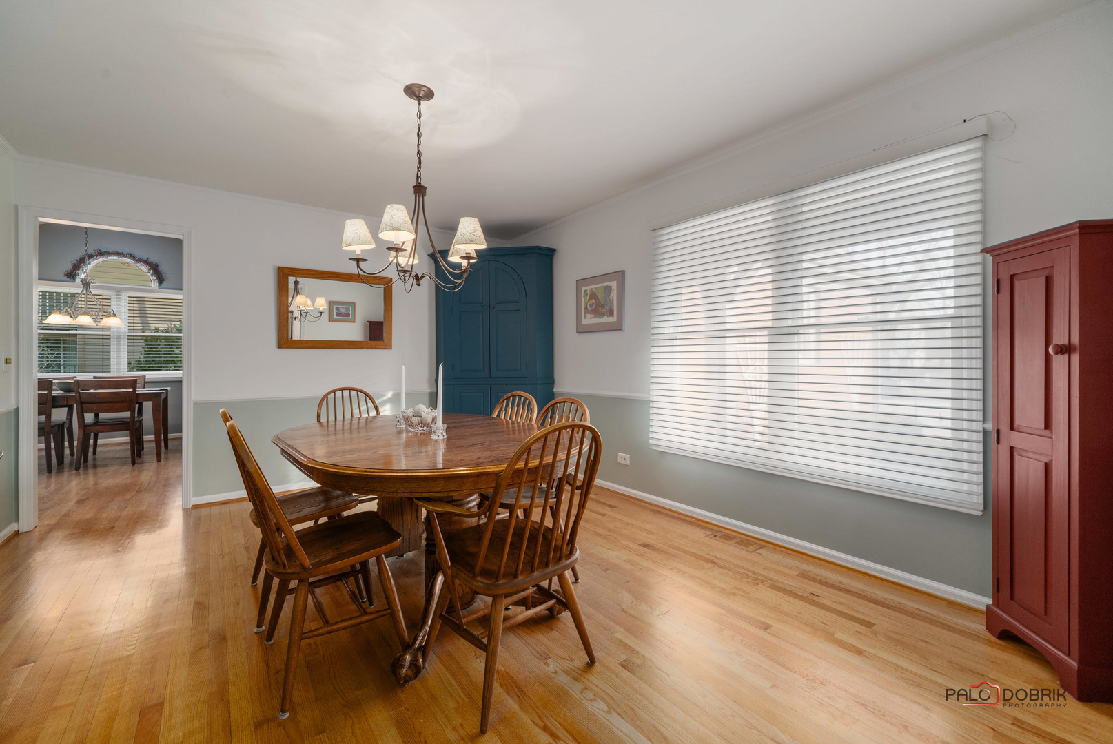 609 Raintree Road Buffalo Grove, IL 60089 - Photo 9 of 48 a dining room with furniture a chandelier and wooden floor