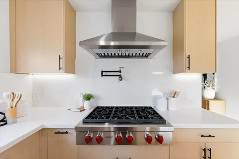 a kitchen with a stove and cabinets