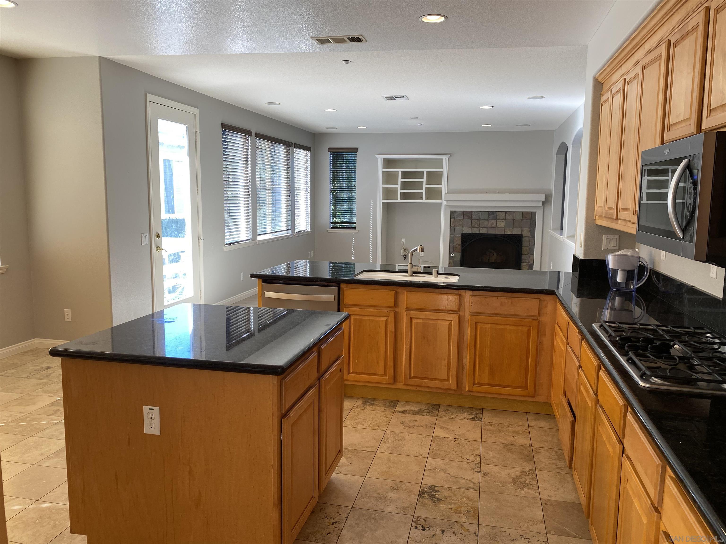 513 Park Lane Encinitas, CA 92024 - Photo 11 of 41 a kitchen with stainless steel appliances granite countertop a sink stove and refrigerator