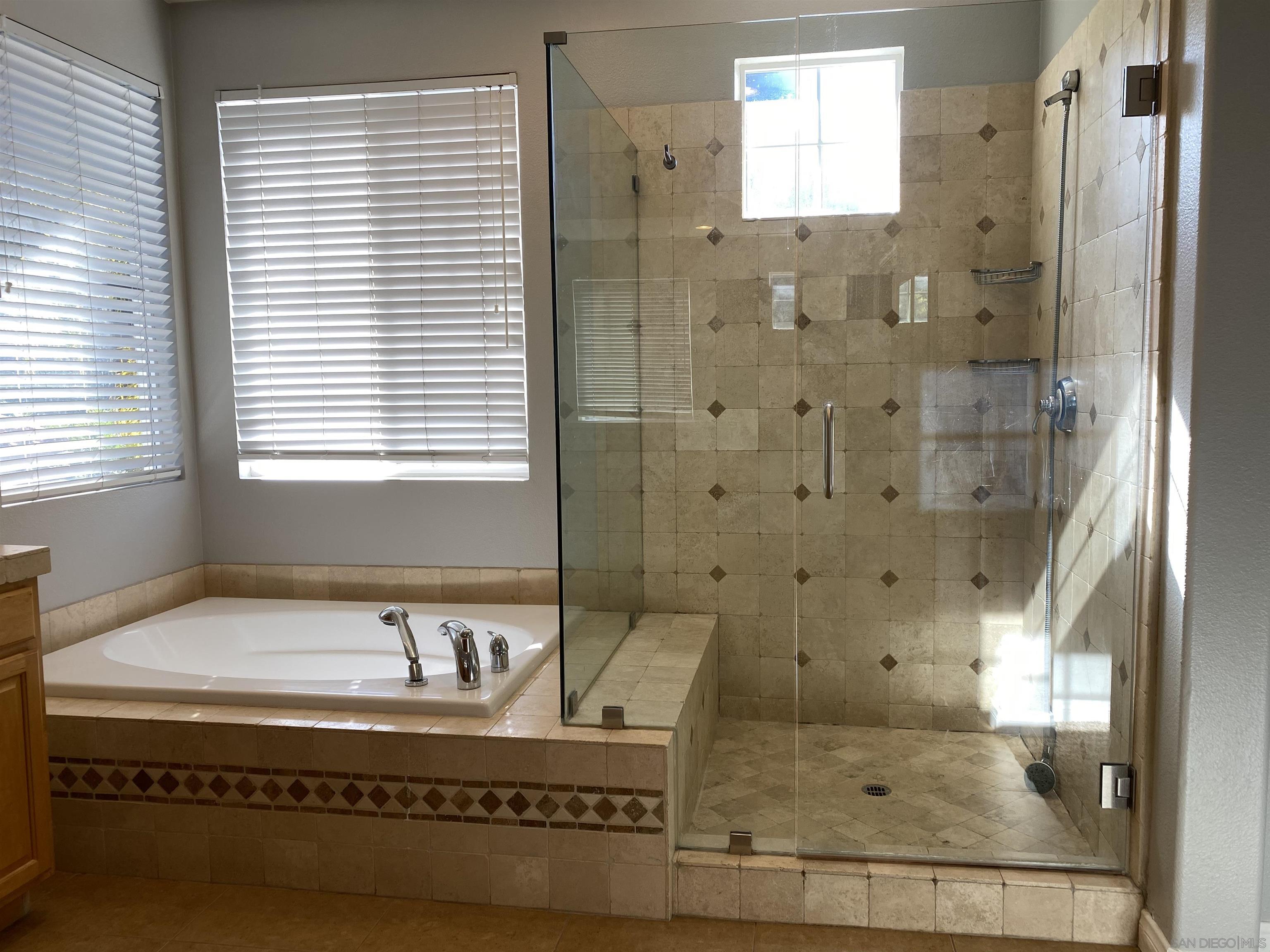 513 Park Lane Encinitas, CA 92024 - Photo 18 of 41 a bathroom with a bathtub and shower