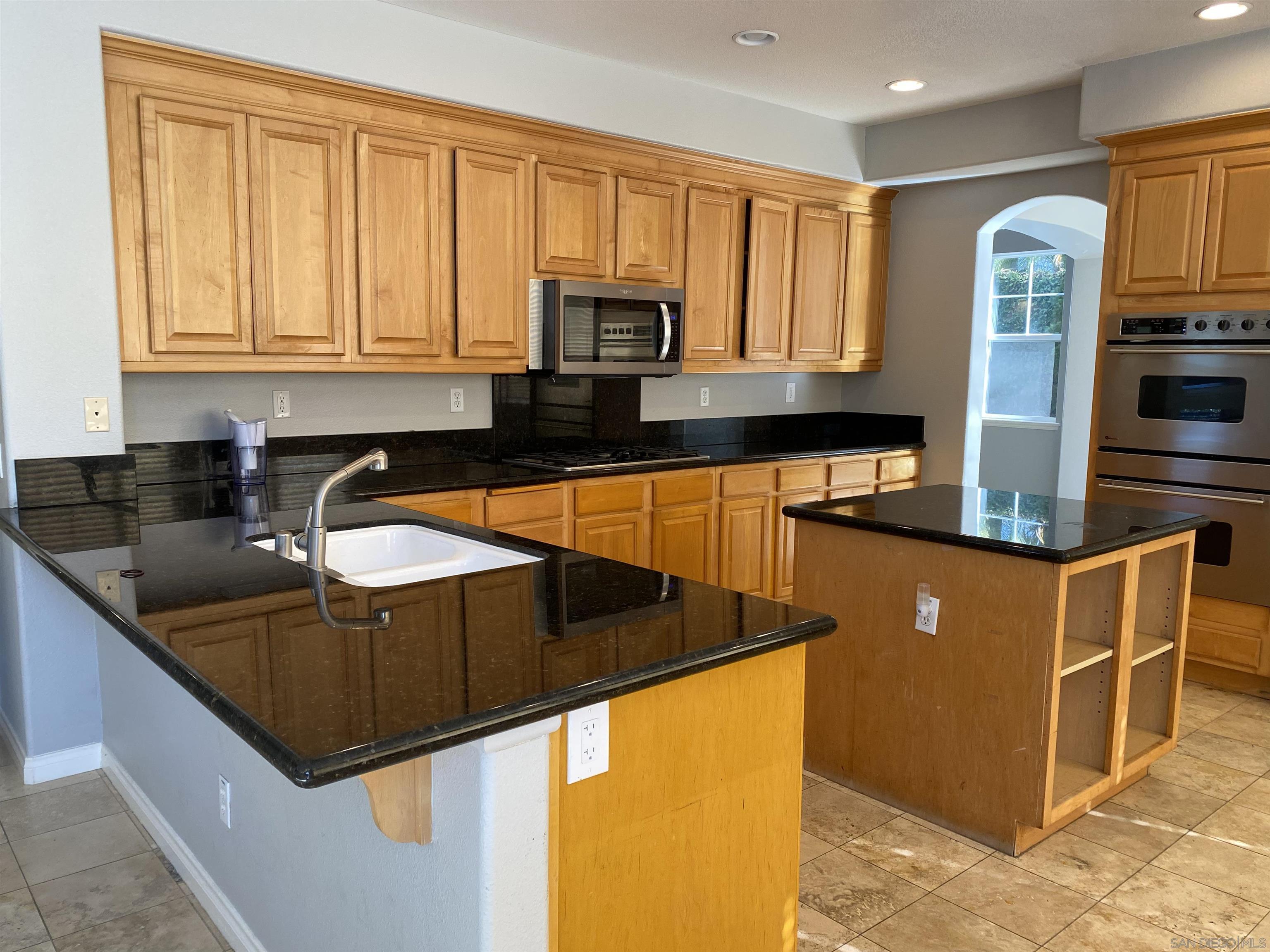 513 Park Lane Encinitas, CA 92024 - Photo 2 of 41 a kitchen with stainless steel appliances granite countertop a sink a stove and a refrigerator