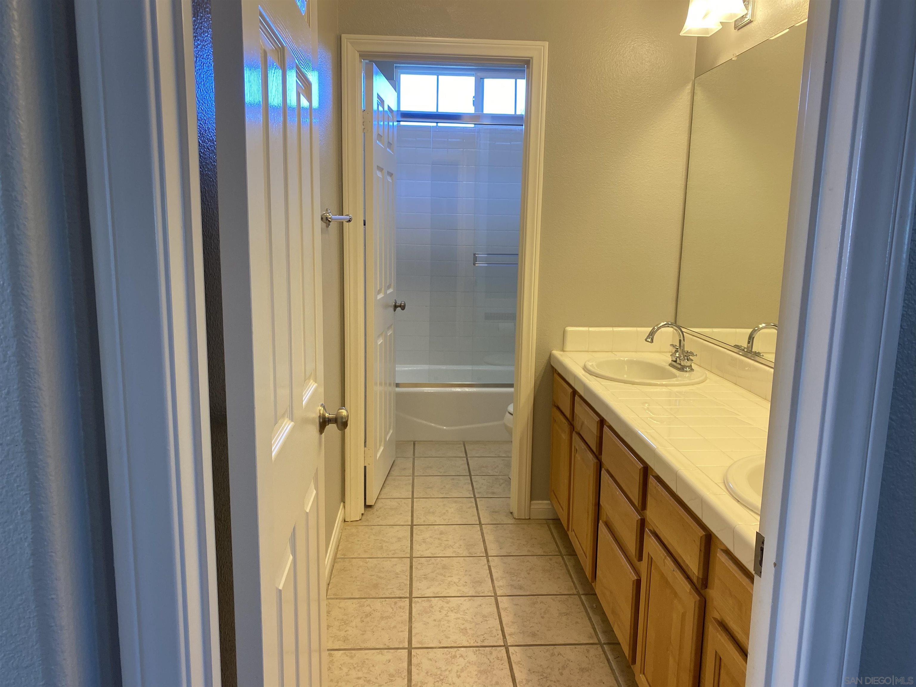 513 Park Lane Encinitas, CA 92024 - Photo 26 of 41 a bathroom with a granite countertop sink and a mirror