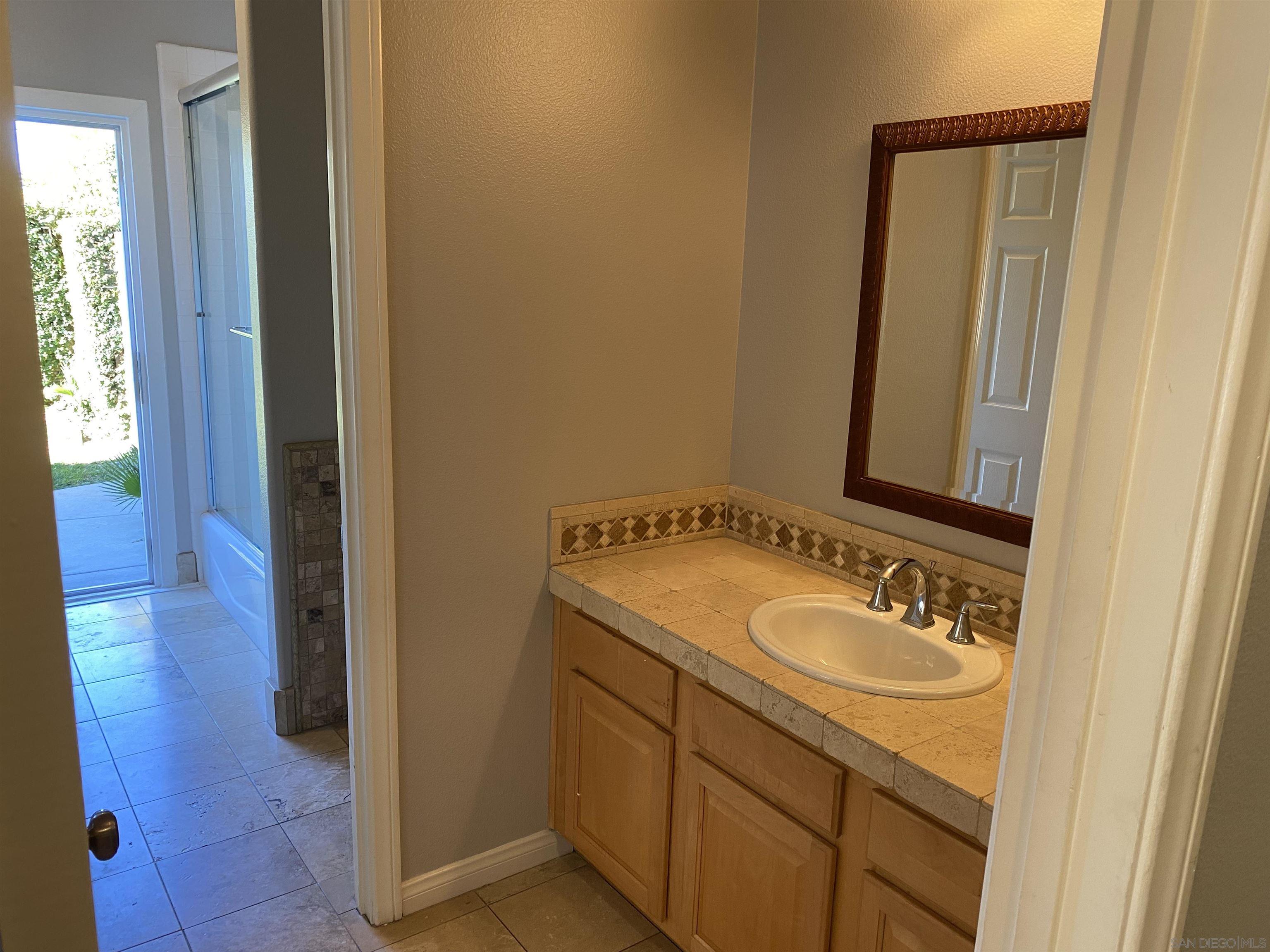513 Park Lane Encinitas, CA 92024 - Photo 29 of 41 a bathroom with a sink and a mirror