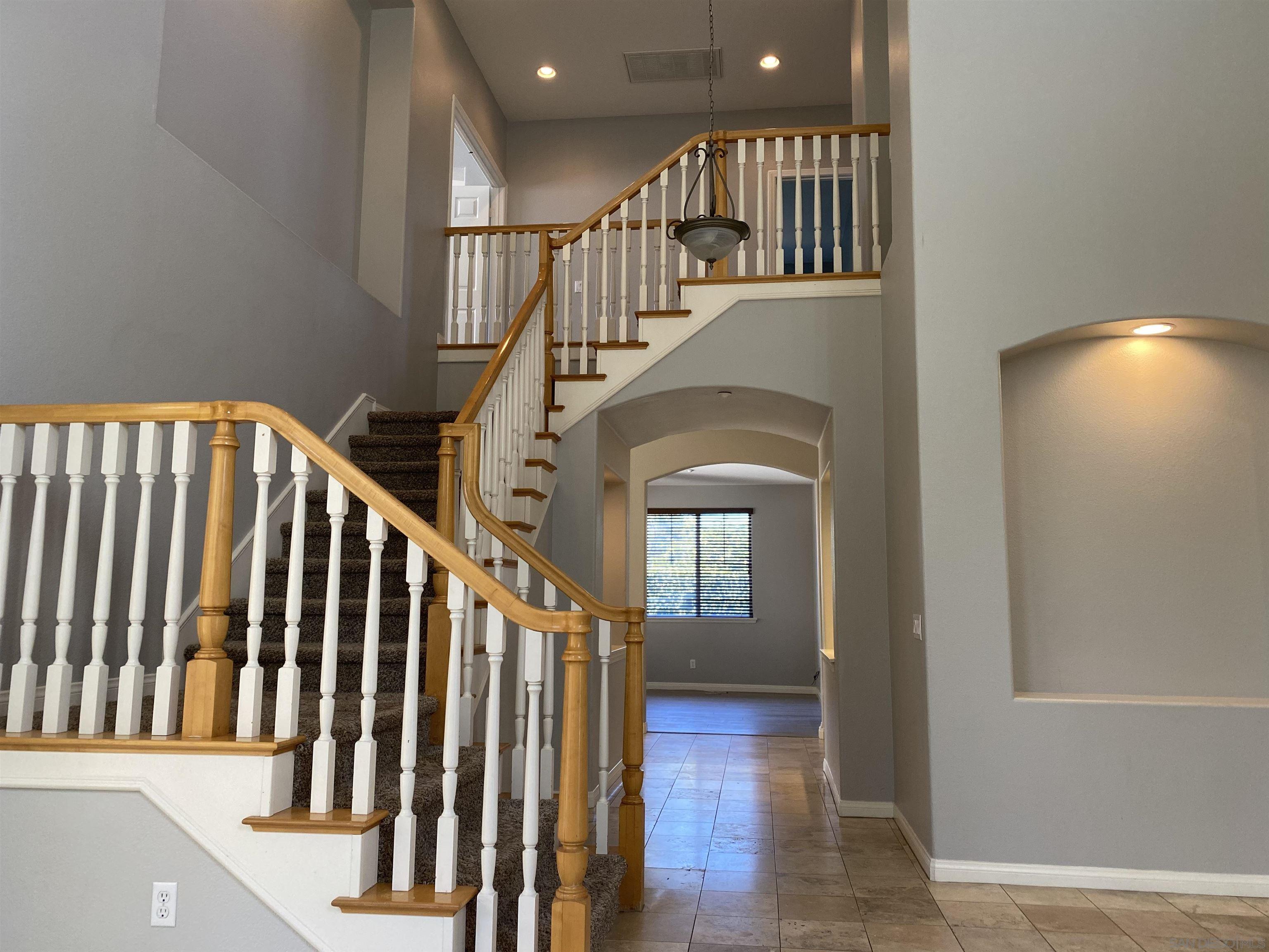 513 Park Lane Encinitas, CA 92024 - Photo 9 of 41 a view of staircase with railing and a chandelier
