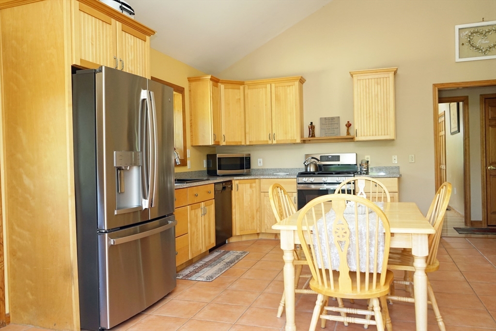 229 Hubbardston Road Templeton, MA 01468 - Photo 8 of 41 a kitchen with stainless steel appliances granite countertop a refrigerator a stove and a sink