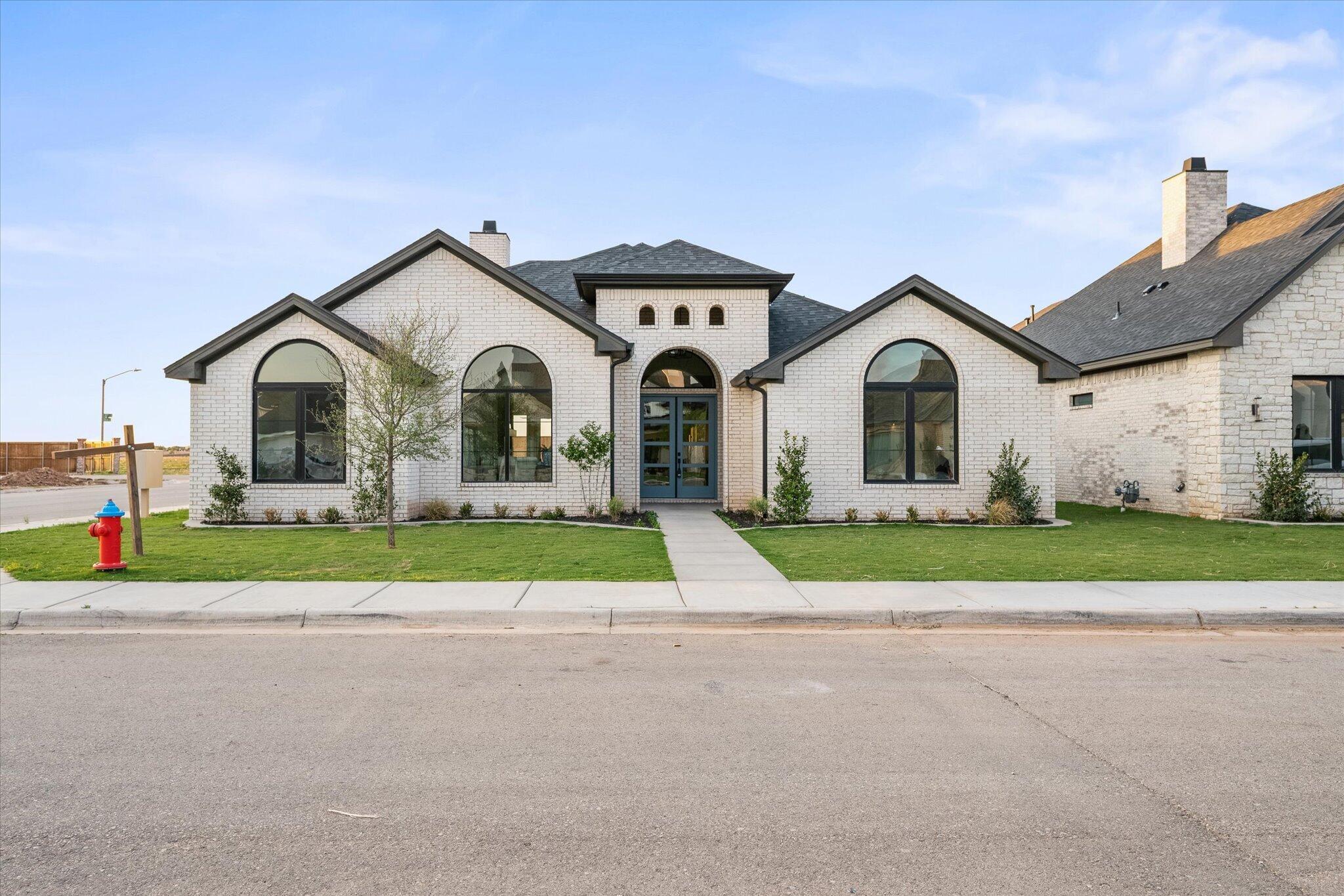 a view of front of house with a yard