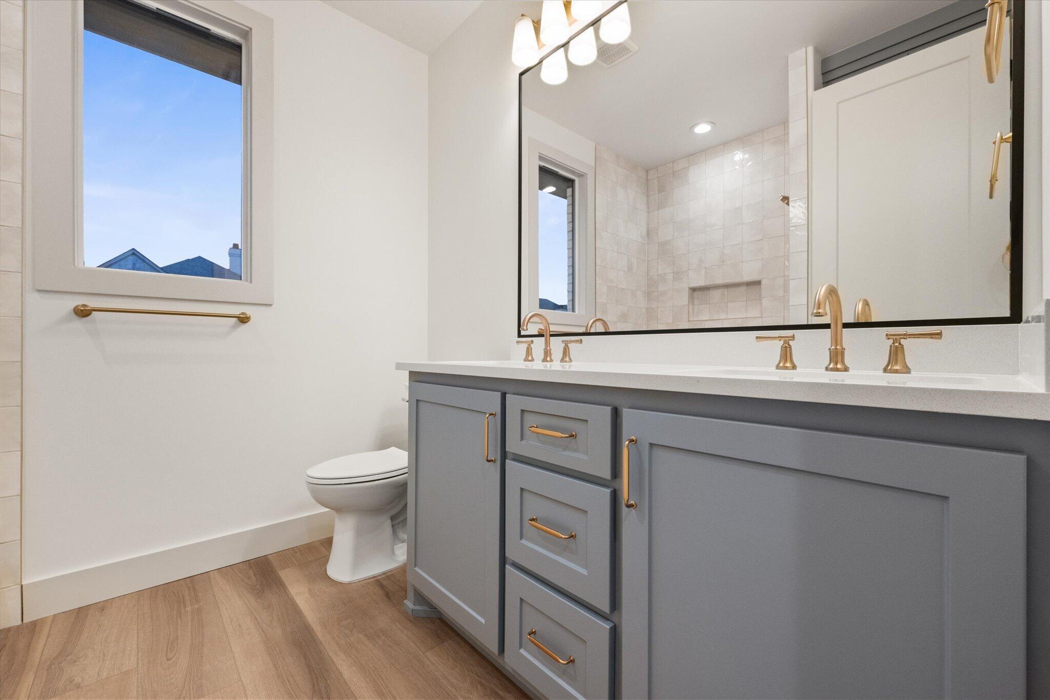 4622 138th Place Lubbock, TX 79424 - Photo 39 of 48 a bathroom with a sink a toilet and a mirror