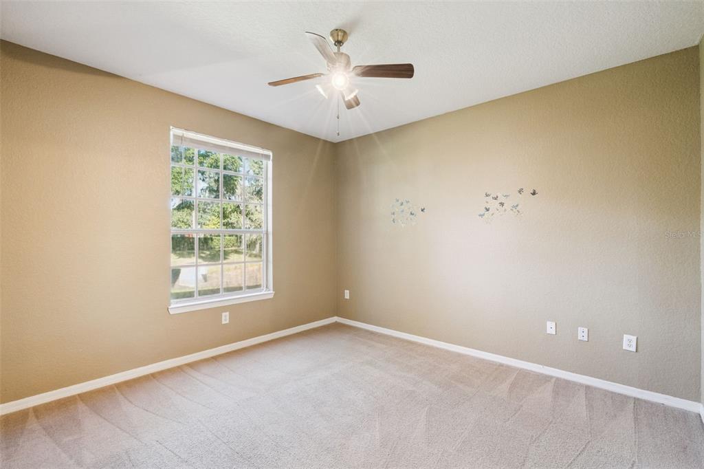 825 Grand Regency Point, Unit 103 Altamonte Springs, FL 32714 - Photo 13 of 20 an empty room with a window and a ceiling fan