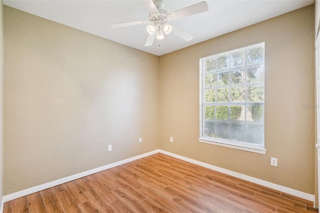 825 Grand Regency Point, Unit 103 Altamonte Springs, FL 32714 - Photo 16 of 20 a view of an empty room with wooden floor and a window
