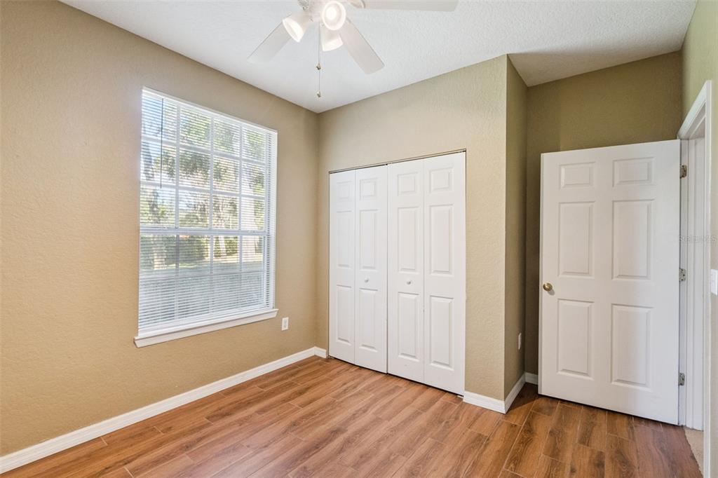 825 Grand Regency Point, Unit 103 Altamonte Springs, FL 32714 - Photo 17 of 20 an empty room with wooden floor cabinet and windows