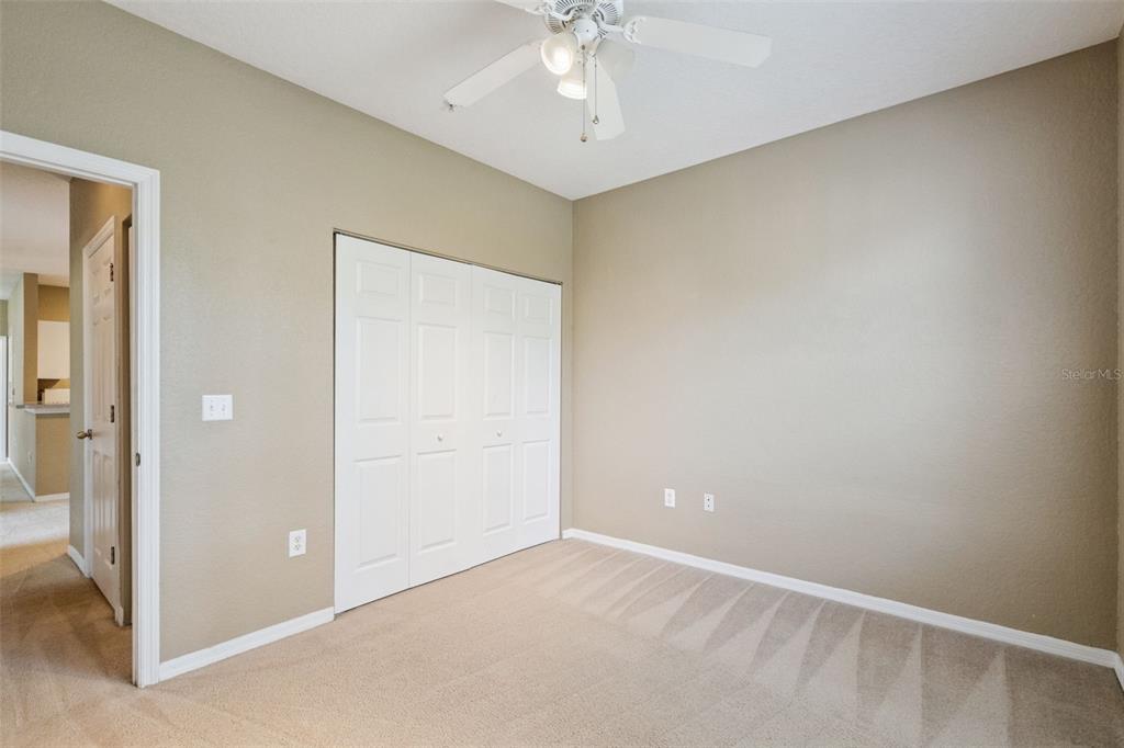 825 Grand Regency Point, Unit 103 Altamonte Springs, FL 32714 - Photo 19 of 20 an empty room with a chandelier fan and closet area