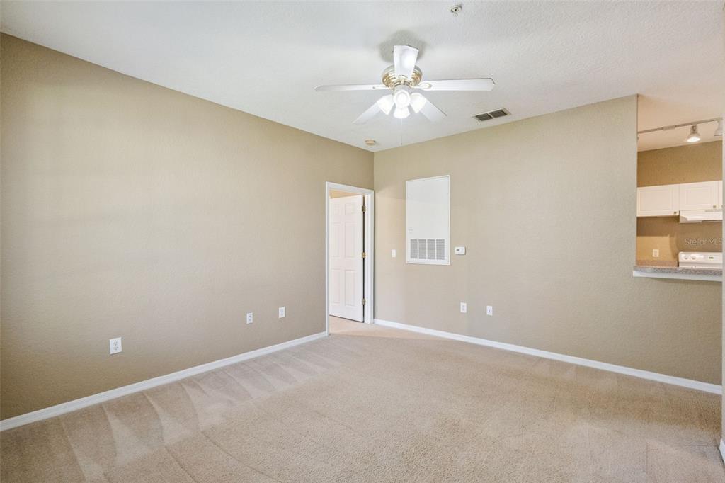 825 Grand Regency Point, Unit 103 Altamonte Springs, FL 32714 - Photo 5 of 20 a view of an empty room with a chandelier fan