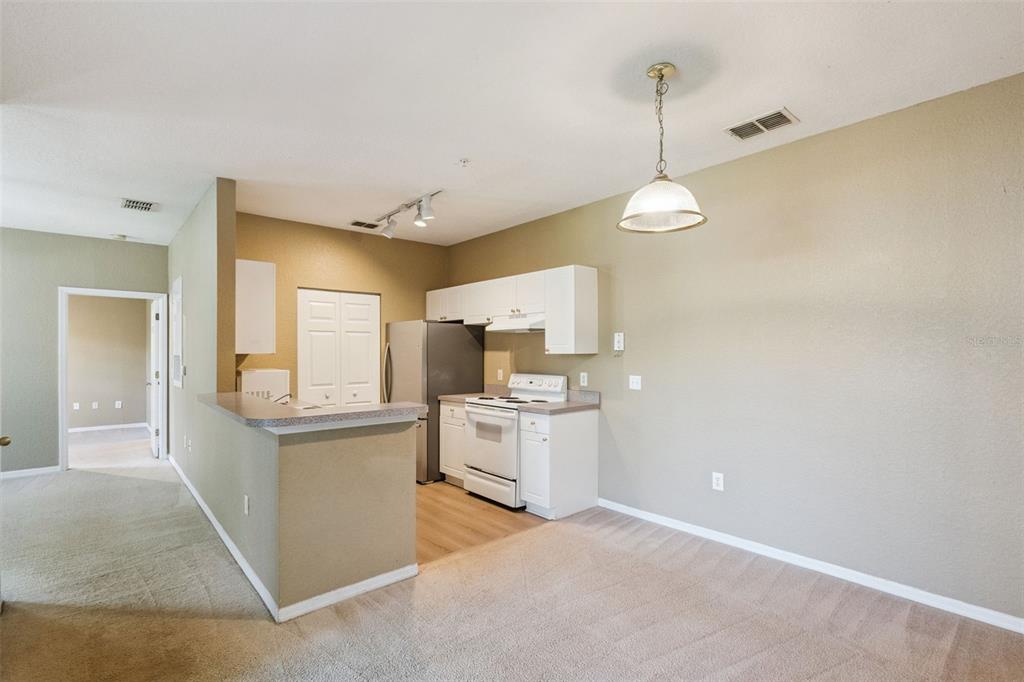 825 Grand Regency Point, Unit 103 Altamonte Springs, FL 32714 - Photo 7 of 20 a kitchen that has a lot of white cabinets and stainless steel appliances