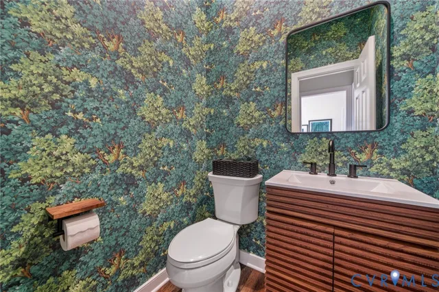 a white toilet sitting next to a bathroom sink