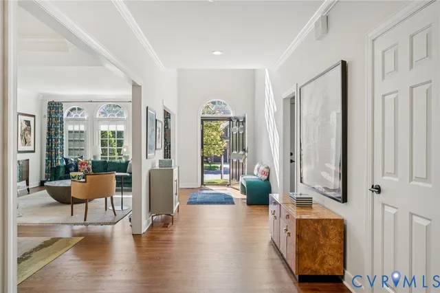 a living room with furniture and wooden floor