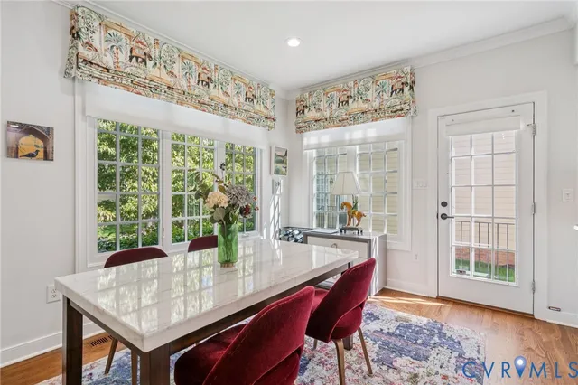 a view of a dining room with furniture window and wooden floor