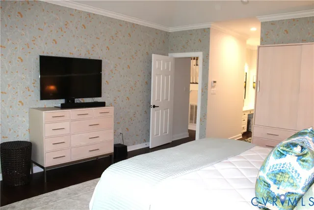a bedroom with a bed and flat screen tv