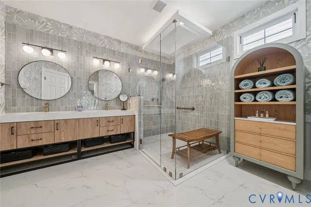 a spacious bathroom with a double vanity sink and a mirror