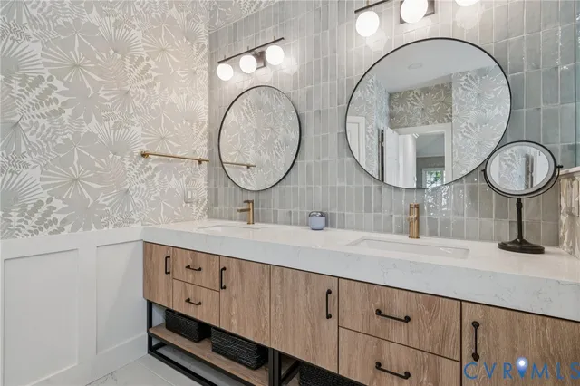 a bathroom with a double vanity sink and a mirror