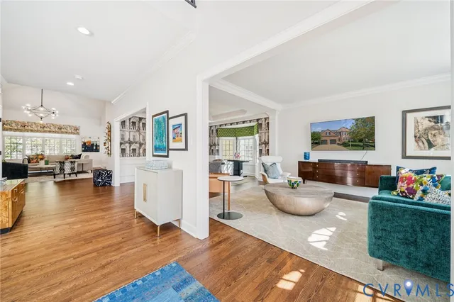 a kitchen view with wooden floor and living room
