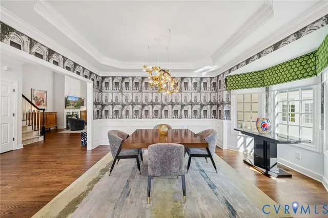 a dining room with furniture and wooden floor