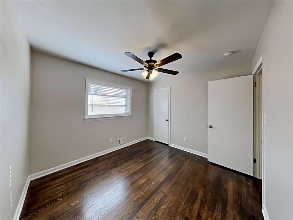 3148 Thrasher Circle Decatur, GA 30032 - Photo 12 of 20 a view of an empty room with wooden floor and a ceiling fan