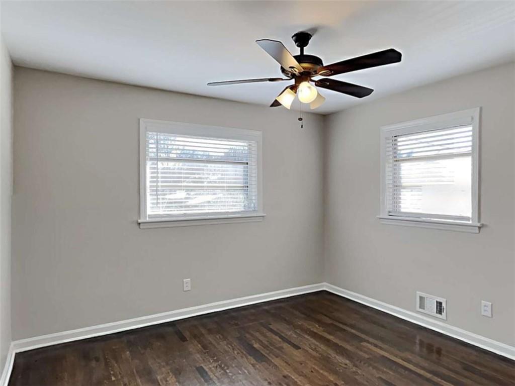 3148 Thrasher Circle Decatur, GA 30032 - Photo 13 of 20 a view of an empty room with wooden floor and a window