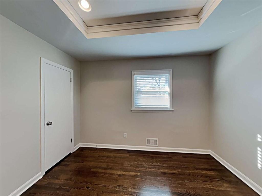 3148 Thrasher Circle Decatur, GA 30032 - Photo 14 of 20 a view of an empty room with wooden floor and a window