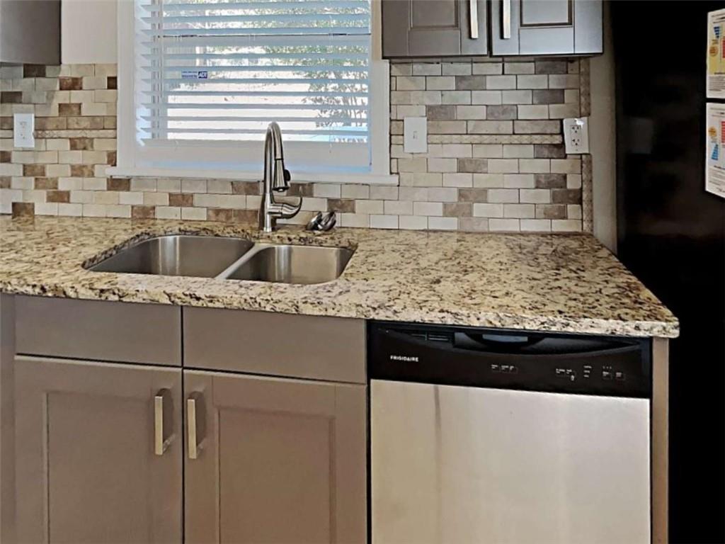 3148 Thrasher Circle Decatur, GA 30032 - Photo 16 of 20 a kitchen with a sink and wooden cabinets