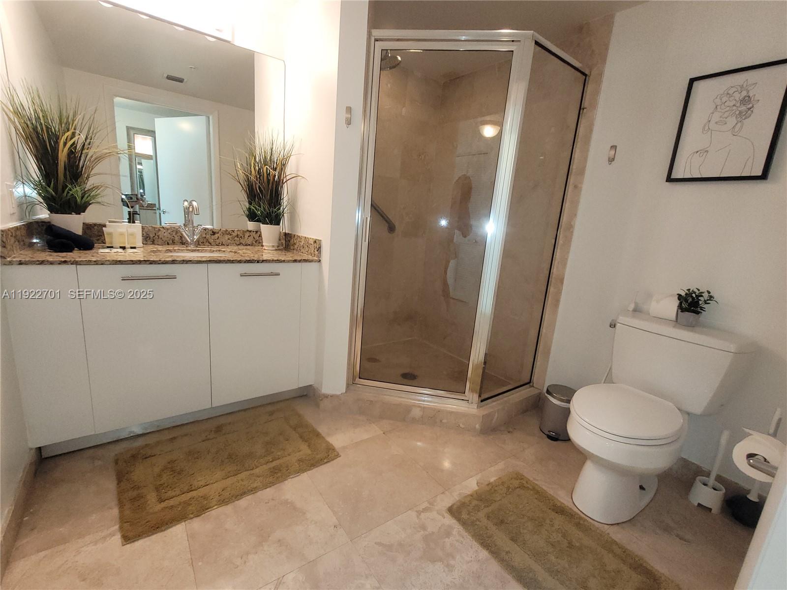 41 Southeast 5th Street, Unit 710 Miami, FL 33131 - Photo 8 of 14 a bathroom with a sink toilet and shower