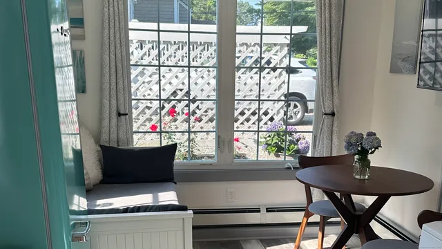 a view of a dining room with furniture and window