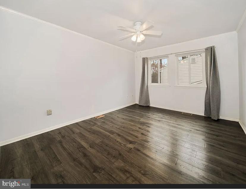 9481 Farewell Road Columbia, MD 21045 - Photo 14 of 18 a view of an empty room with wooden floor and a window