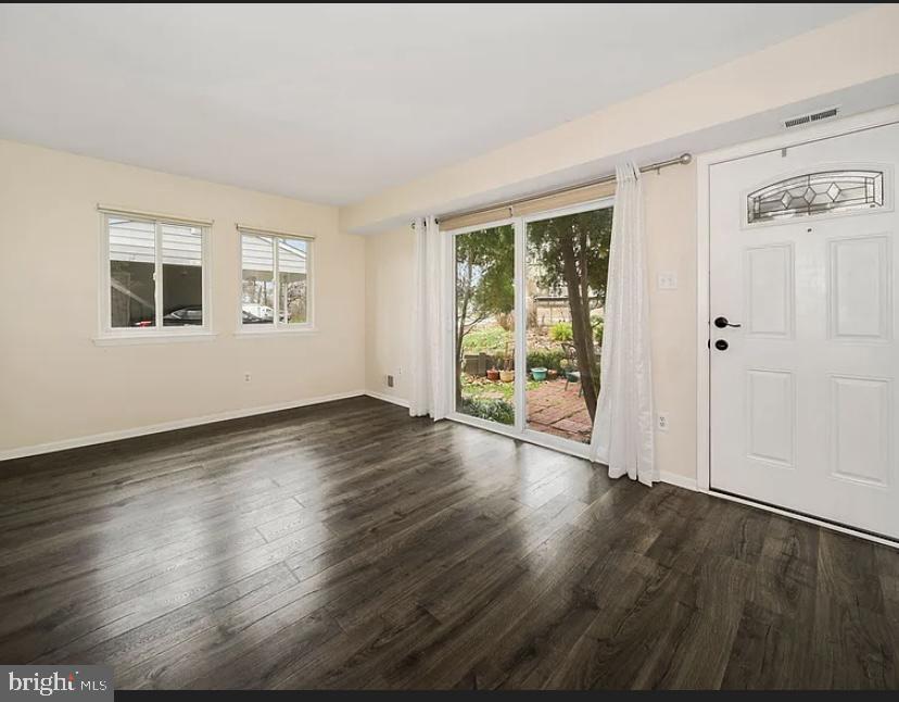 9481 Farewell Road Columbia, MD 21045 - Photo 2 of 18 a view of an empty room with wooden floor and a window