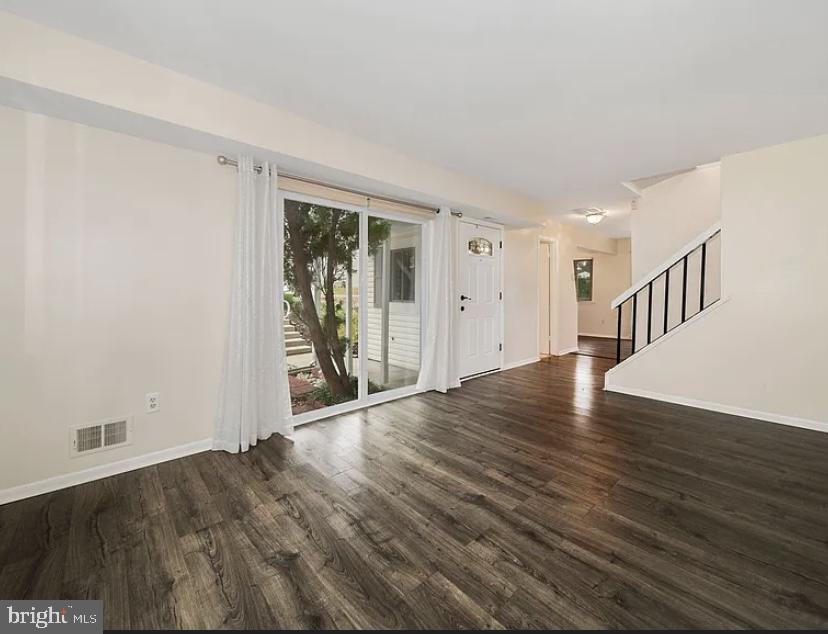 9481 Farewell Road Columbia, MD 21045 - Photo 3 of 18 a view of an empty room with wooden floor and a window