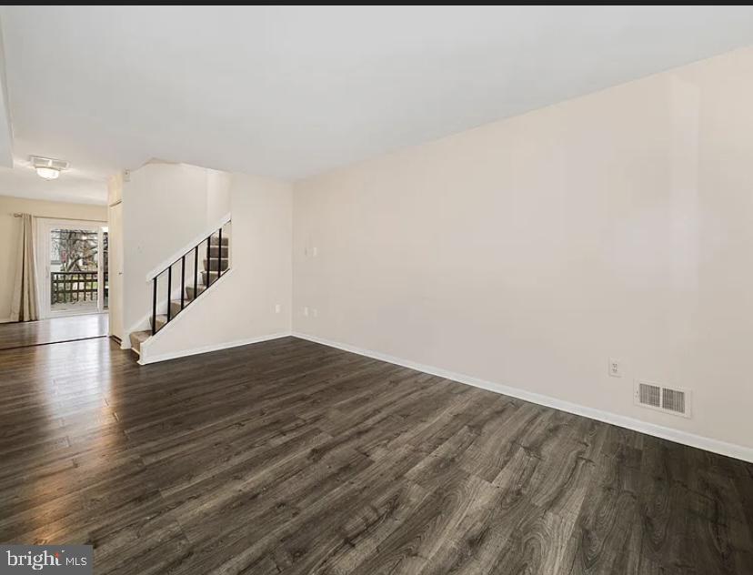 9481 Farewell Road Columbia, MD 21045 - Photo 4 of 18 a view of an empty room with wooden floor