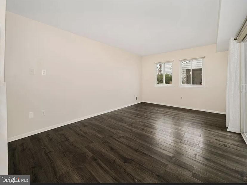 9481 Farewell Road Columbia, MD 21045 - Photo 5 of 18 an empty room with wooden floor and windows