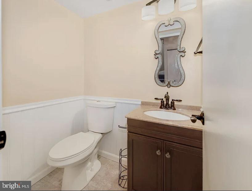 9481 Farewell Road Columbia, MD 21045 - Photo 6 of 18 a bathroom with a toilet sink and mirror