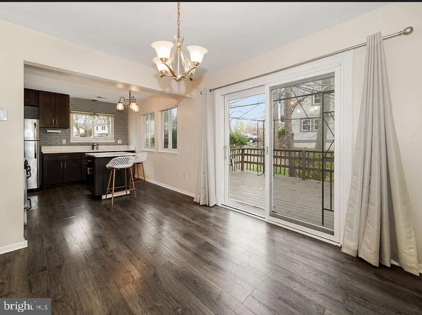 9481 Farewell Road Columbia, MD 21045 - Photo 8 of 18 a view of a dining room with furniture wooden floor and chandelier